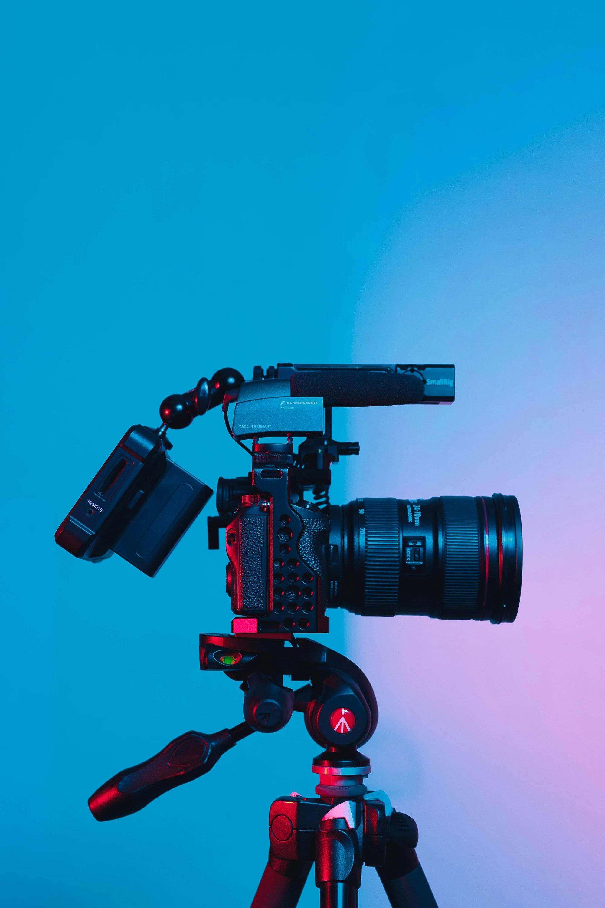 A professional video camera with a zoom lens and microphone