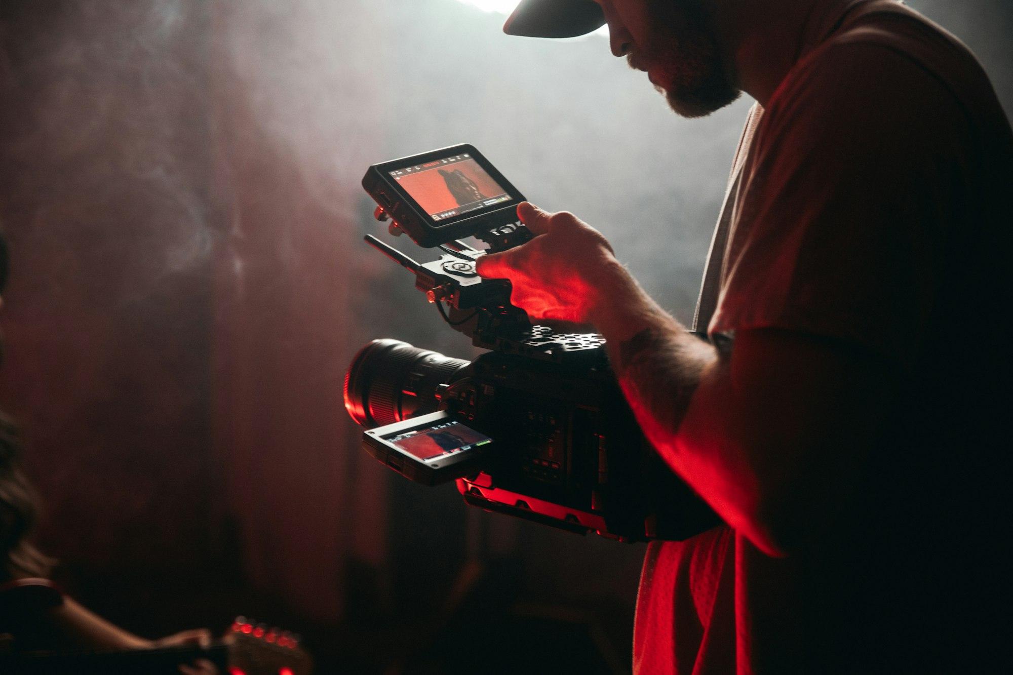 A videographer filming on a professional cinema camera