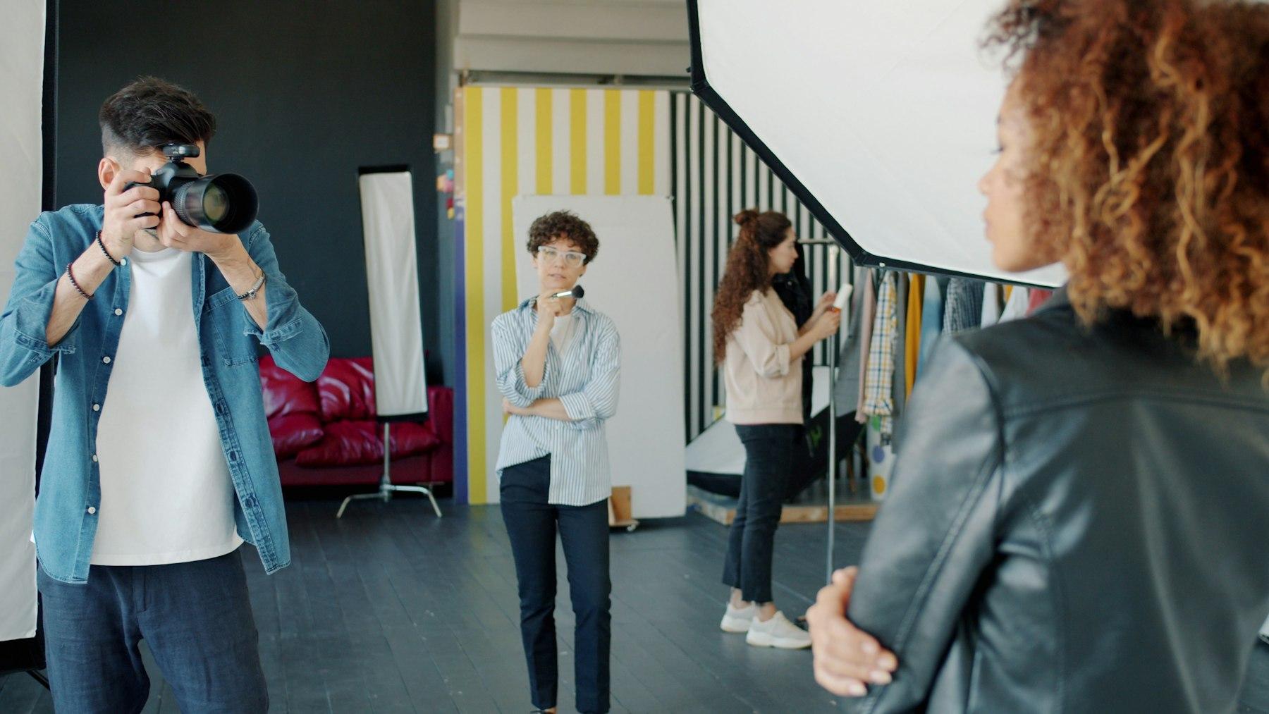 A photographer shooting a model in a studio