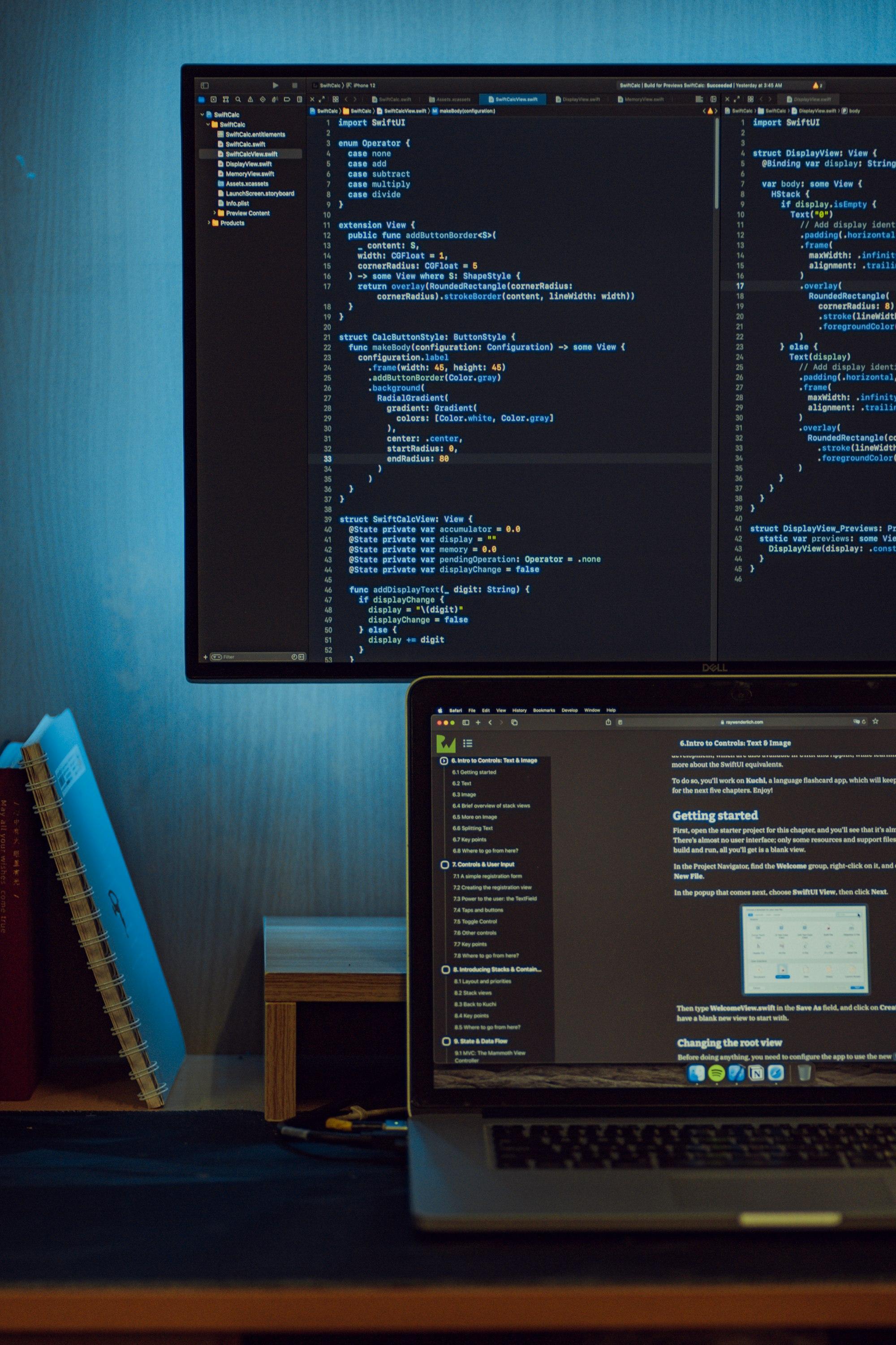 Code on a monitor and a laptop